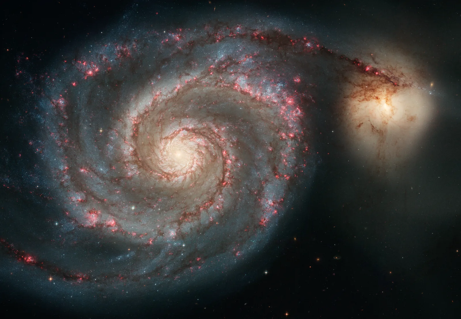 The Whirlpool Galaxy — one system, turning as a whole