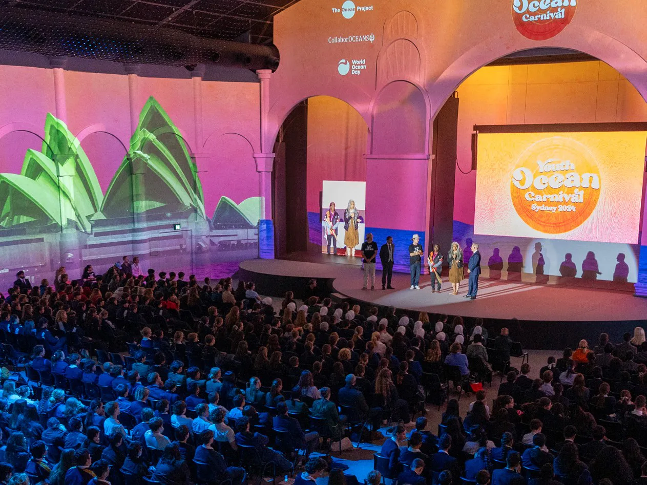 Youth Ocean Carnival — a packed auditorium with a projection-mapped stage